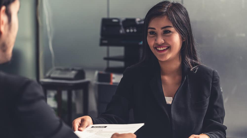 Human resource manager interviewing the male employment candidate in the office room. Happy job interview. Job application, recruitment, job offer